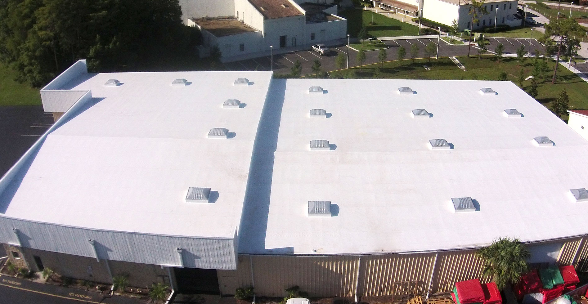 drone image of a flat white roof with skylights 