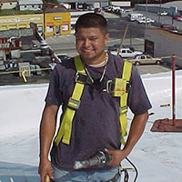 smiling commercial roofer CentiMark employee in full safety gear