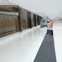 two engineers talking on a factory roof standing on walkpads