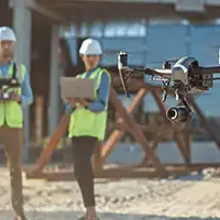 drone operators on construction site