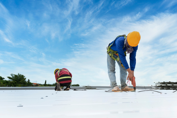 two men working on a white roof